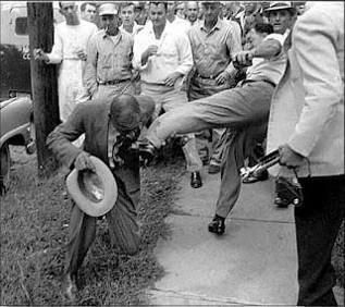 A black news reporter is attacked by whites at Little Rock's Central High School. This image was shown around the world