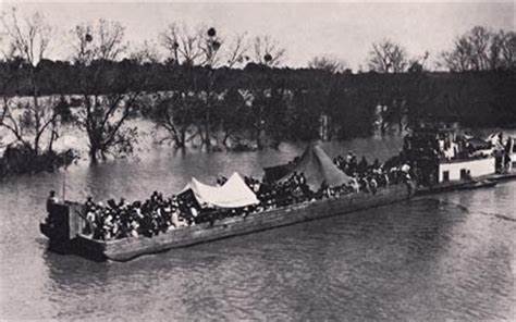 A large group of slaves being transported on a barge on the Mississippi River.