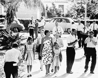 Black parents escort their children into Miami's all-white Orchard Villa Elementary school on first day of school desegregation in Dade County in 1960. The school was all-black by Christmas.