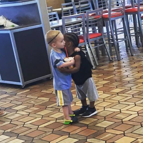 Children two strangers hugging in a fast food restruant int 