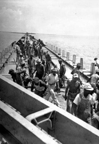 Converting the tracks of the Florida East Coast Railway into a new bridge for automobiles in the Florida Keys_ ca. 1937.