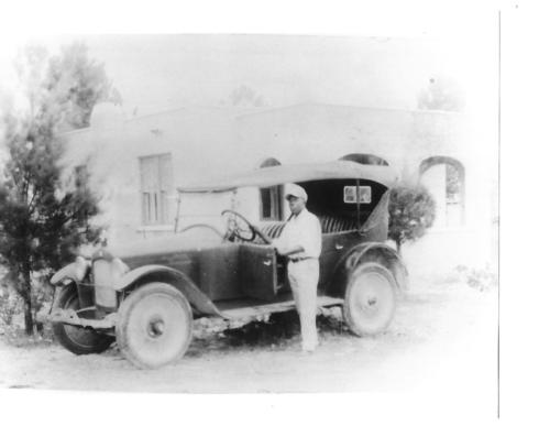 Horace Sharpe Jr. in front of one of the first homes in Miami's Liberty City.