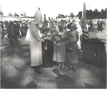 KKK- A baby being inducted into the Ku Klux Klan in south Dade County circa 1940s