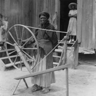 Lucindy Lawrence Jurdon with her mother's spinning wheel  1937  Alabama