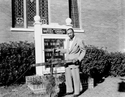 Tallahassee civil rights leader Reverend C. K. Steele holds a cross that was burned on the property of his church in 1956. FAMU students rallied round Rev_ Stelle who led the movement in Tallahasse 